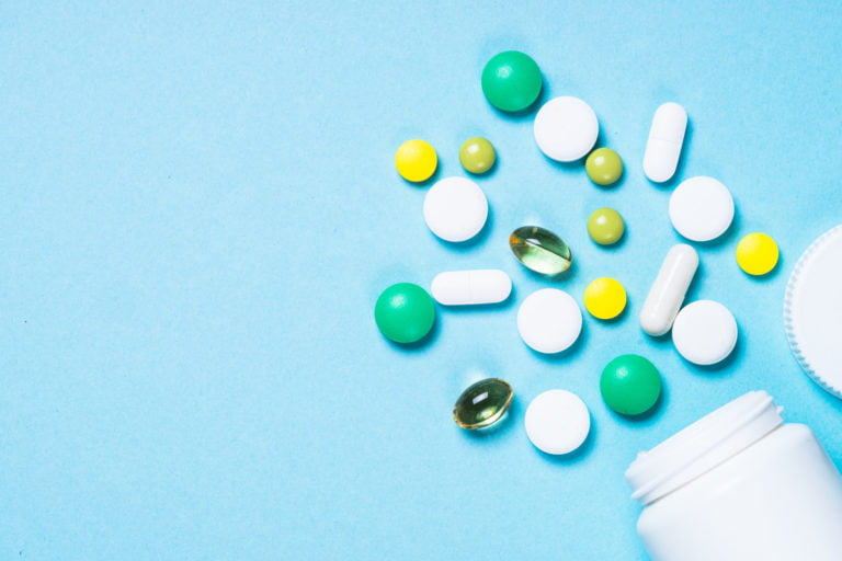a group of different colored pills