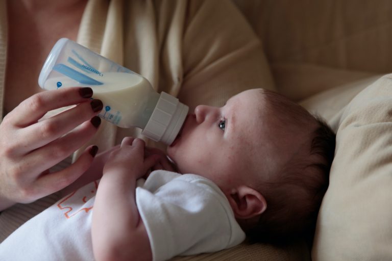 a baby holding a cell phone
