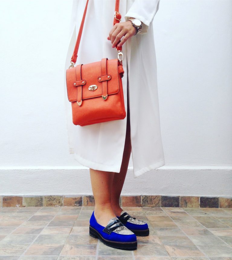 a person wearing a red purse and a red purse
