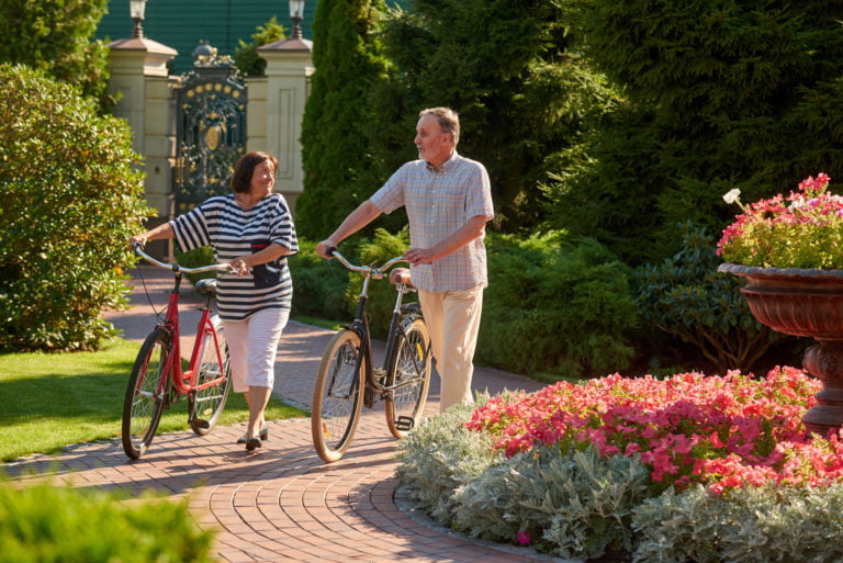 a man and woman holding bikes