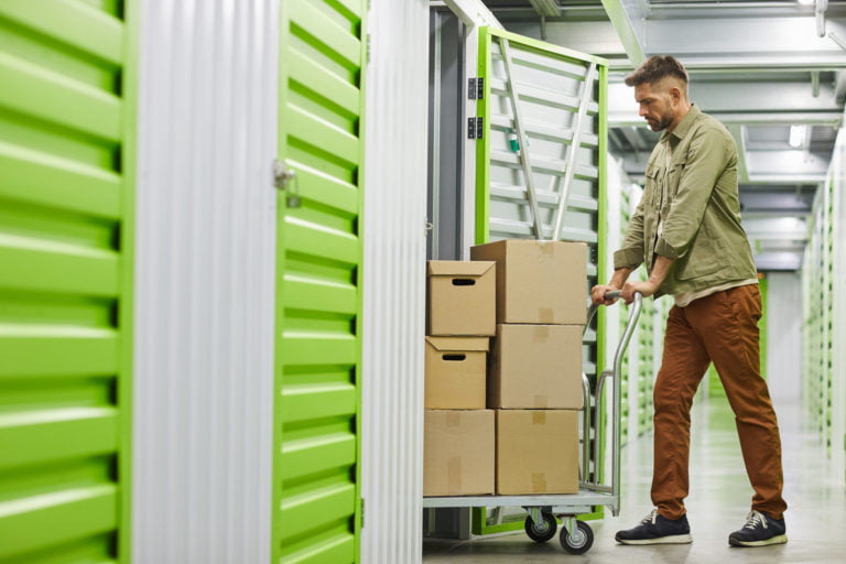 Man Moving Boxes in Storage Unit