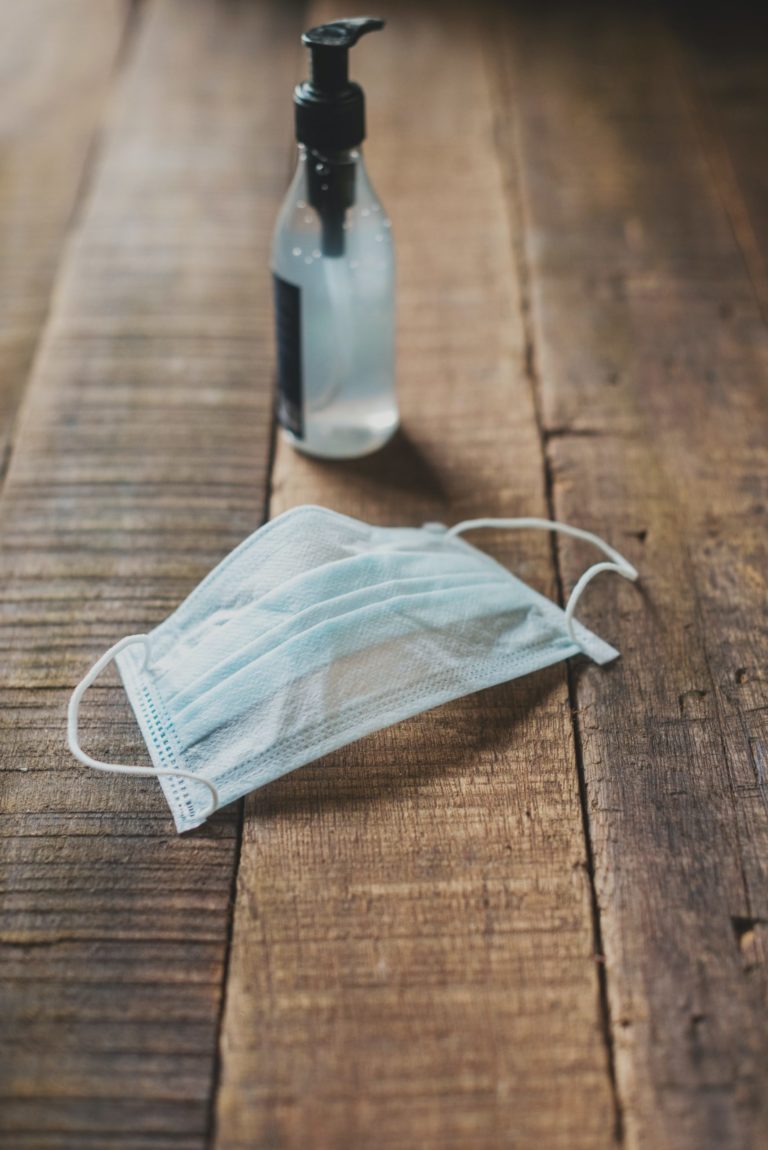 a glass bottle on a wood table