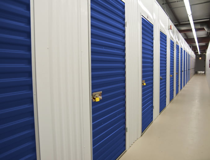 a long hallway with blue doors