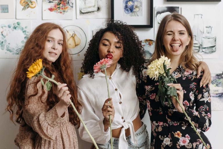 a group of women holding flowers