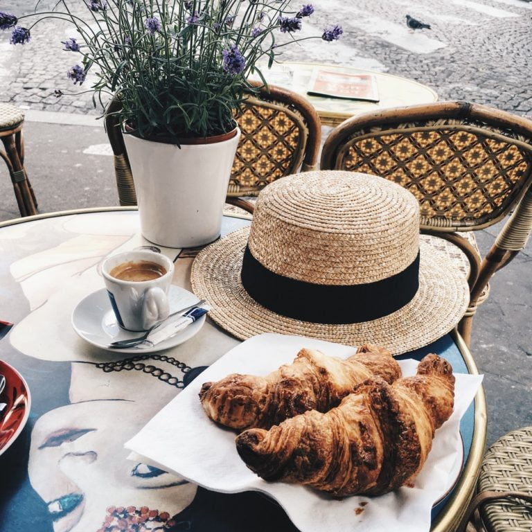 a table with a plate of food and a potted plant