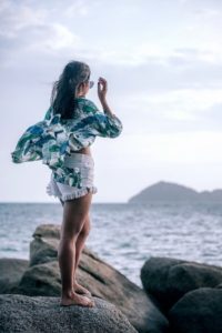 a woman standing on a rock