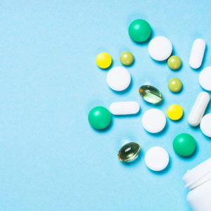 a group of different colored pills