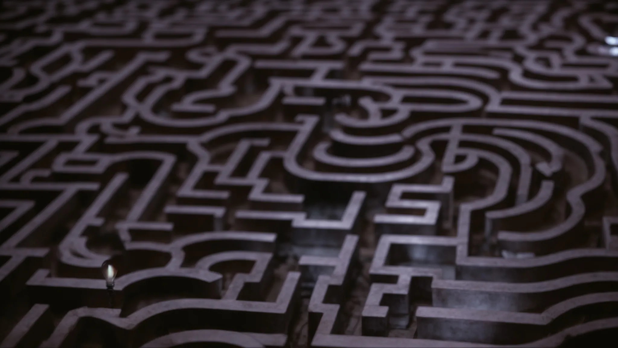 a light bulb illuminates over a maze, highlighting a straight path through it.