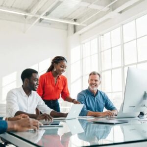 Digital marketing agency team collaborating on press release software in a modern office